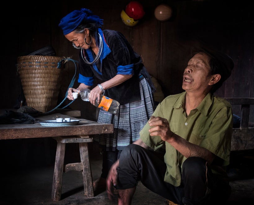 <strong>We were invited into this home for homemade rice wine being poured out of an old Fanta bottle. The husband here had
