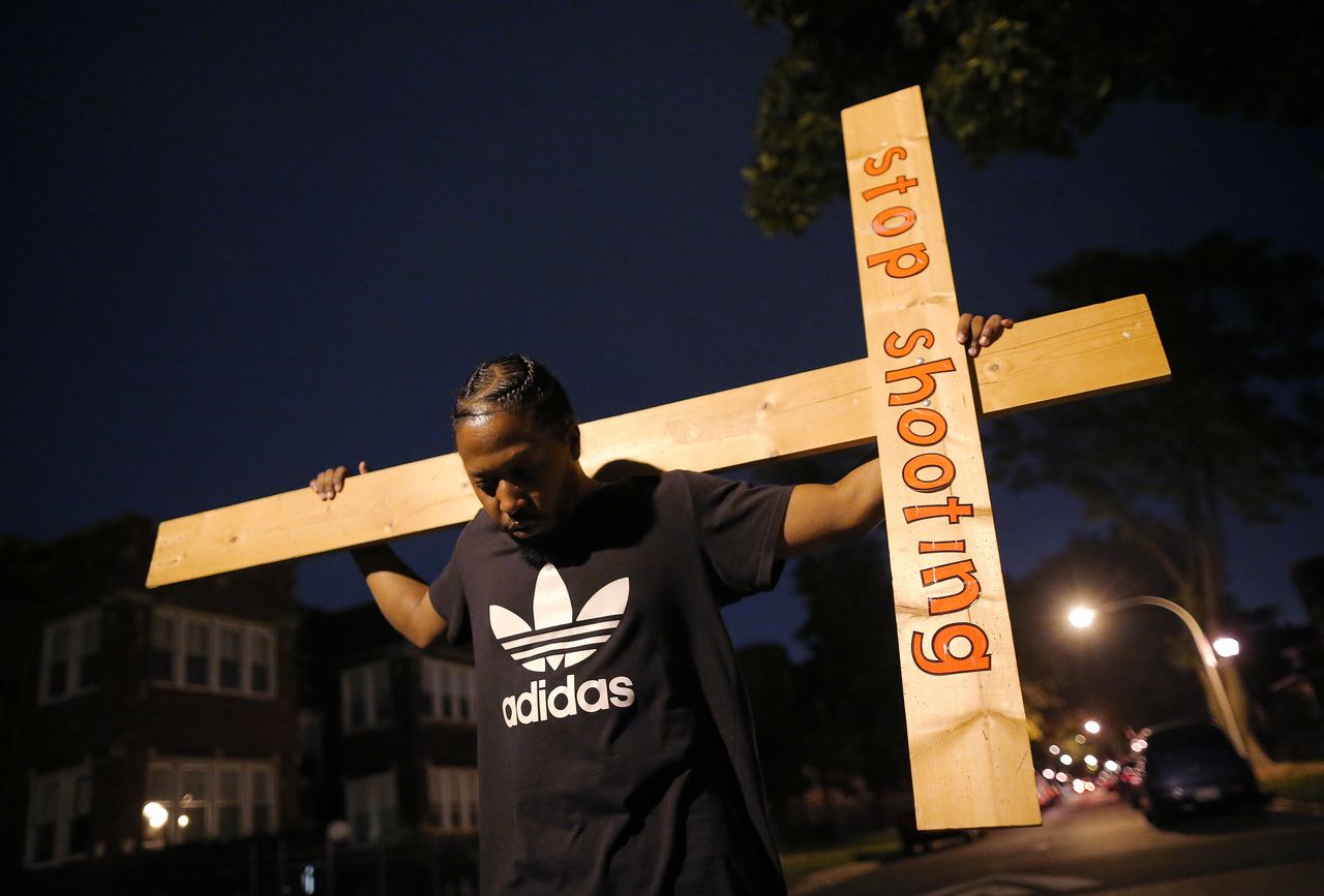 A protester takes part in a weekly nighttime peace march through the streets of a South Side Chicago neighborhood on September 16, 2016.