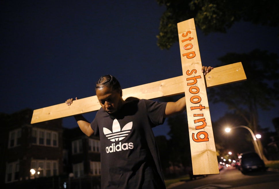 A protester takes part in a weekly nighttime peace march through the streets of a South Side Chicago neighborhood on Septembe