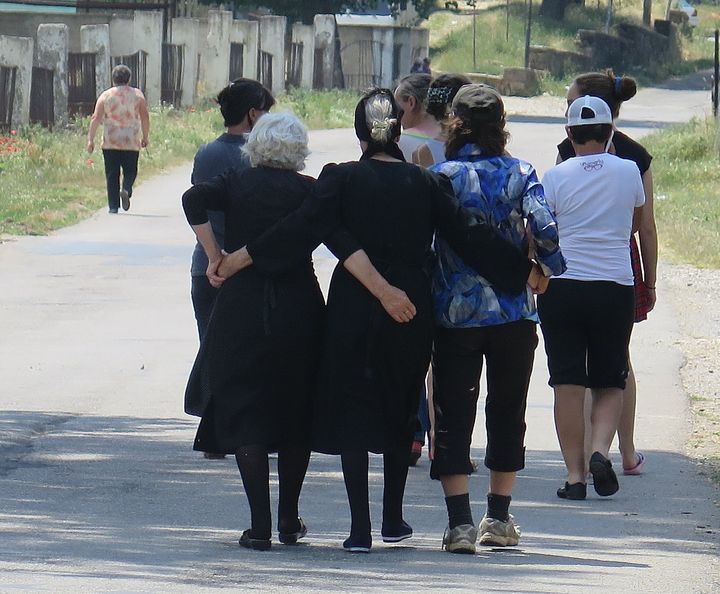 Ladies walking down the road in the Albania countryside 