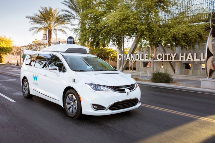 One of Waymo's self-driving minivans passes by the city hall in Chandler, Arizona, in this undated Waymo handout.