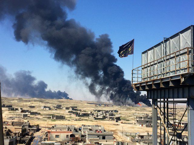 Smoke rises above Qayyarah displacement camp in March 2017.