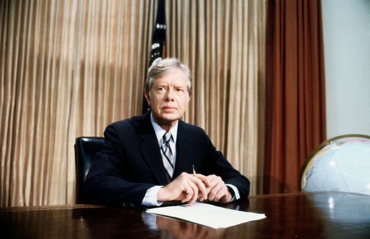 A grim-faced President Jimmy Carter, in the Oval Office, tells of the aborted rescue effort intended to free 53 American