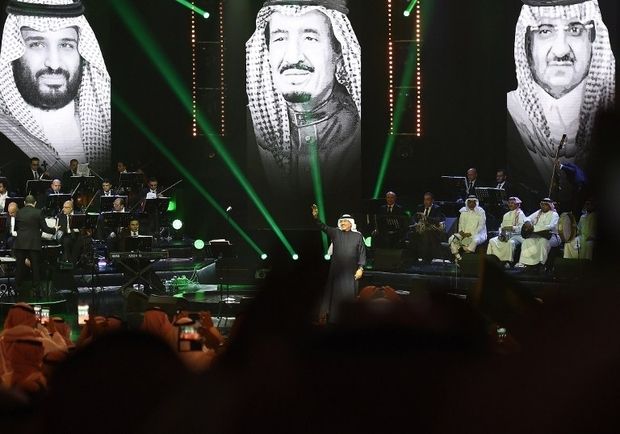 <p>Saudi singer Mohammed Abdu - known as Saudi's 'Paul McCartney - performs in Riyadh in March 2017 with Mohammed bin Salman, King Salman and Mohammed bin Nayef projected in the background (AFP)</p>