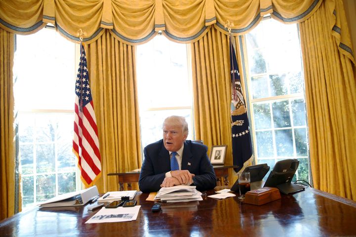 Trump sits at his desk in the White House's Oval Office during an interview in February. An iced beverage can be seen to his left.