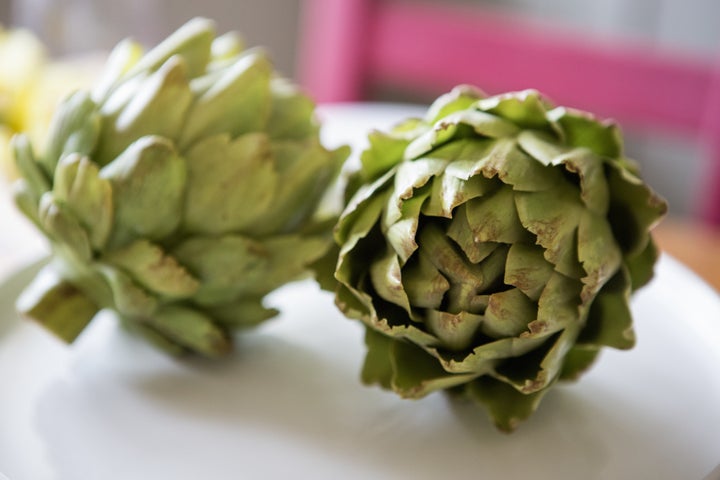 Two artichokes, spines and all.