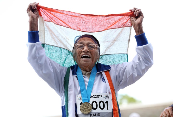 101-year-old Man Kaur from India celebrates after competing in the 100m sprint in the 100+ age category at the World Masters Games.