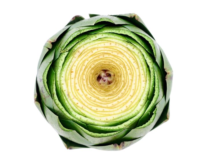 A look at the center of an artichoke with the top quarter of it trimmed off.