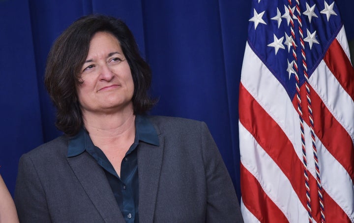 Patagonia CEO Rose Marcario is seen on stage with President Barack Obama as he speaks during an event highlighting important middle class issues on April 16, 2015, in Washington, D.C.