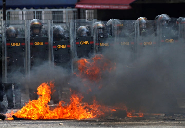 Riot police officers clash with opposition supporters during a rally against Venezuela's President Nicolas Maduro in Caracas.