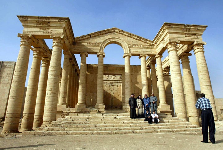 Arab foreigners take a picture in front of a temple in the historic city of Hatra in December 2002