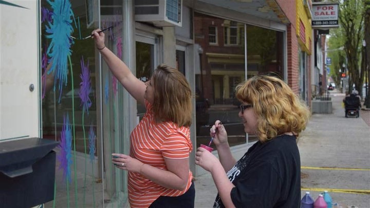 Pocomoke High School teacher Brooke Gillespie and senior Rebeka Kline, who plans to study art at a local community college, decorate vacant storefronts in rural Pocomoke City, Maryland, as part of an after-school program to teach job skills. “After they graduate, there isn’t much here” for young people looking for jobs, Gillespie said.