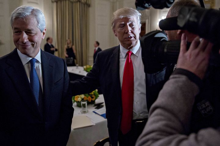 Trump stands next to Jamie Dimon, CEO of JPMorgan Chase & Co., in the White House on February 3.