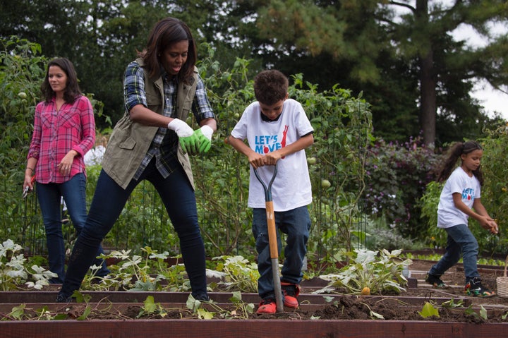 Former first lady Michelle Obama helping kids in the White House Kitchen Garden.