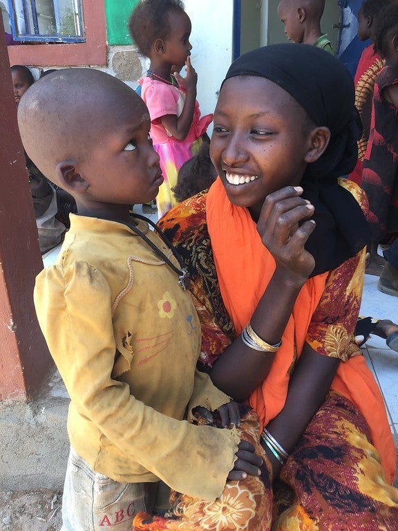 Mother and son wait outside health centre in Bandarero, Marsabit County, Kenya. 3 March 2017 