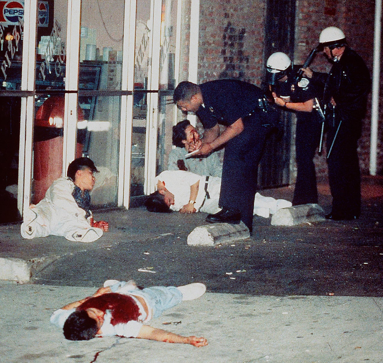 Edward Song Lee, 18, foreground, was shot to death and three other people were injured at 3rd and Hobart streets in Los Angeles' Koreatown on April 30, 1992. Police questioned the survivors of the attack, who were shot while trying to protect a Korean-owned pizza parlor.