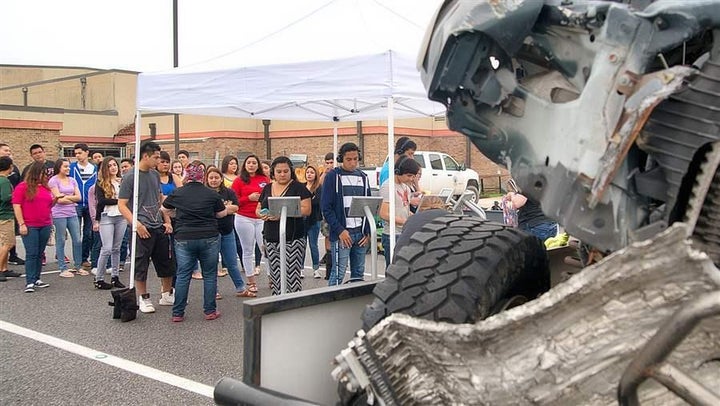 Students from Harlingen High School South in Texas view the remains of a truck demolished in a crash in which two teens survi