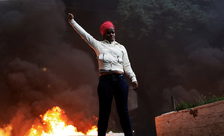 A member of Brazil's Movimento dos Sem-Teto (Roofless Movement) gestures in front of a burning barricade in Sao Paulo, Brazil April 28, 2017.