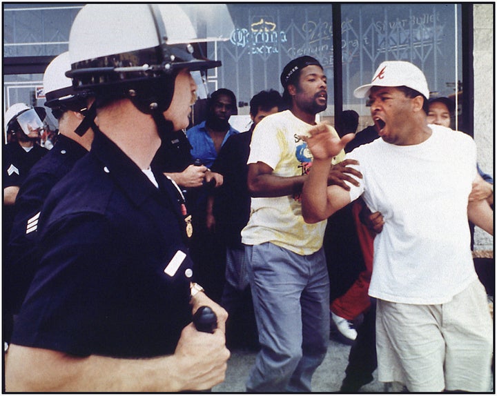An argument between police and civilians preceding a rock and brick throwing incident at the corner of Vermont and 1st Street