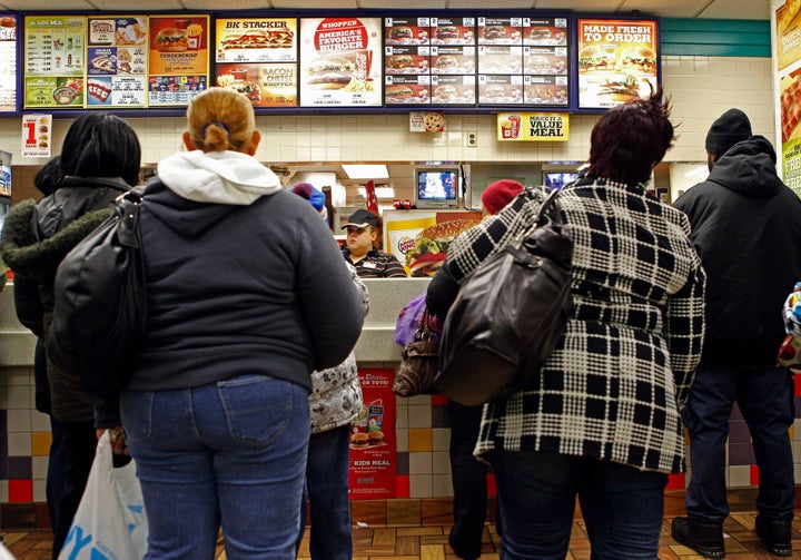 People line up to buy food at a fast food restaurant in Harlem in New York. Minority communities have been inundated with fast food in recent decades.