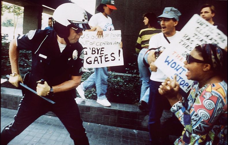 A police officer uses his baton on a protester at the corner of First Street and Broadway on April 29, 1992, in Los Angeles.