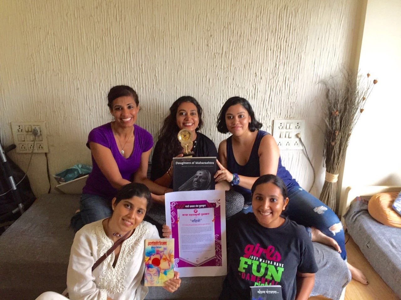 Sahiyo cofounders in Mumbai India displaying an award the organization received for their work on female genital cutting.