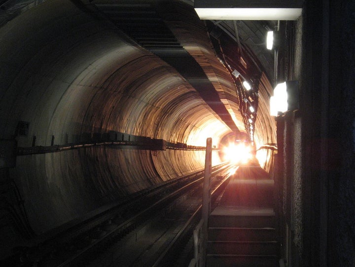 Self-made photo of the bright front light of a subway train in a tunnel approaching a station on the Los Angeles MTA Purple L