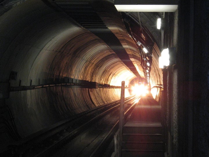 Self-made photo of the bright front light of a subway train in a tunnel approaching a station on the Los Angeles MTA Purple Line. 