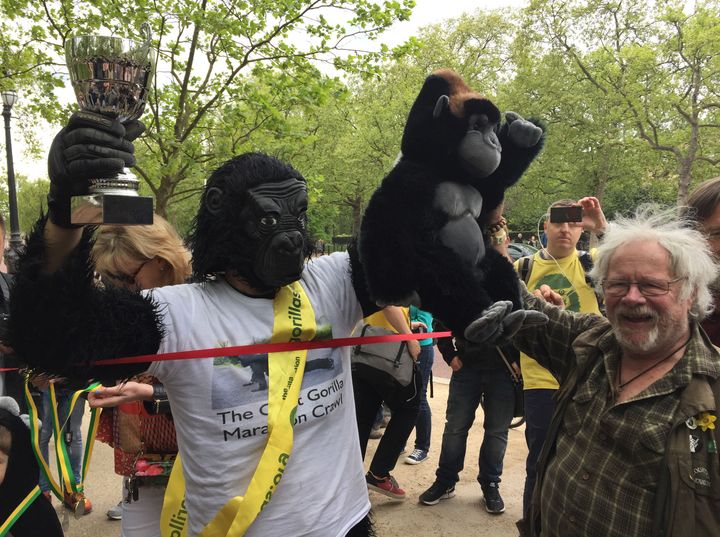 Metropolitan Police officer Tom Harrison, who goes by the name Mr Gorilla, is congratulated by Bill Oddie after crawling across the finish line in The Mall in a gorilla costume to complete the London Marathon.