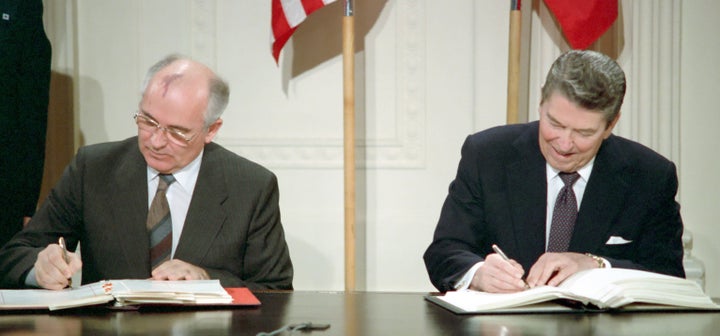 General Secretary Mikhail Gorbachev (left) and U.S. President Ronald Reagan sign the Intermediate-Range Nuclear Forces Treaty in Washington on Dec. 8, 1987.