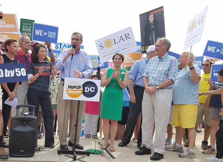 Cong. Nydia Velázquez of New York, Senators Sheldon Whitehouse of R.I., Maria Cantwell of Washington and Jeff Merkley of Oregon, Attorney General Maura Healey of Mass., Sens. Tom Carper of Delaware and Ed Markey of Mass. at press event by the Capitol Reflecting Pool. 