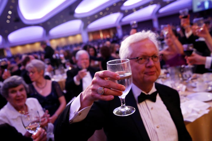 Attendees of the White House Correspondents' Dinner raise a glass to the First Amendment.