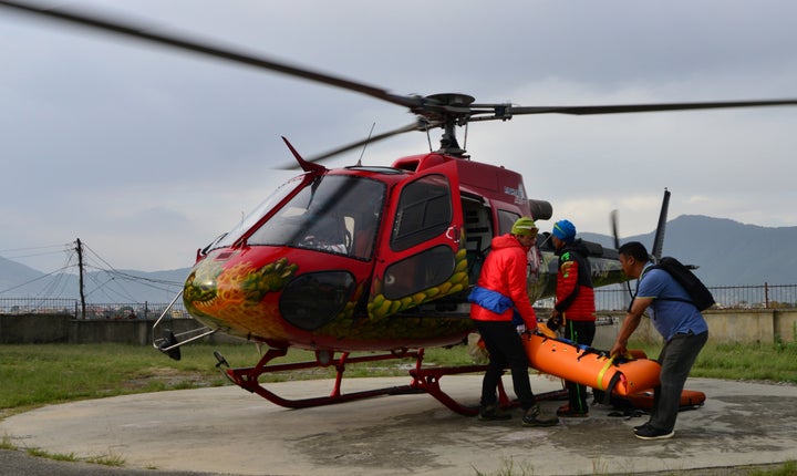 Nepalese volunteers and friends of Steck are seen carrying his body to a hospital in Kathmandu on Sunday.