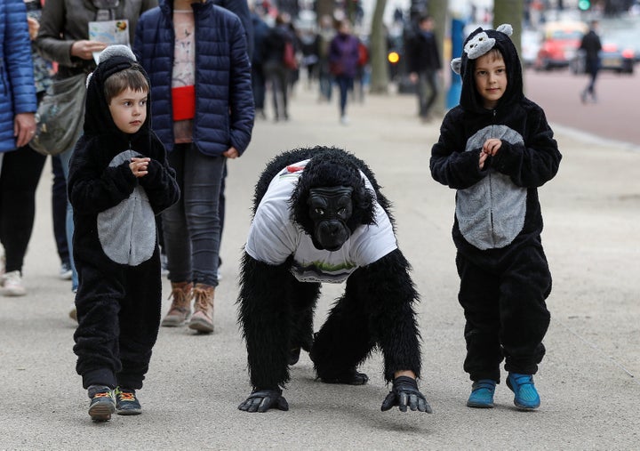 Metropolitan Police Officer Tom Harrison is seen crawling toward the finish line of the London Marathon, accompanied by his two sons.