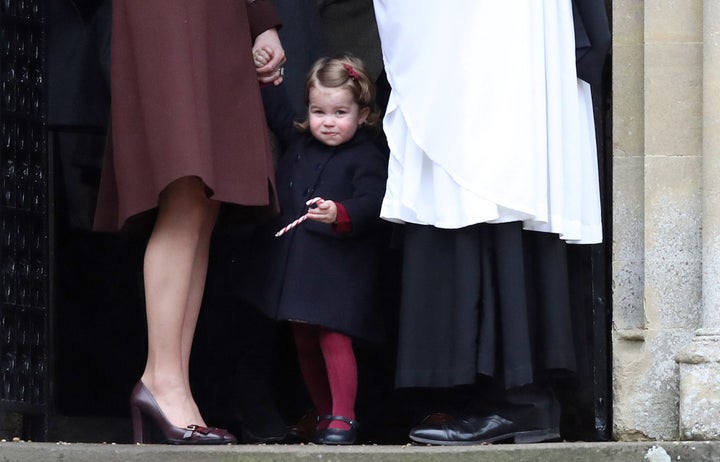 Princess Charlotte holds her mother, Catherine, The Duchess of Cambridge's hand (L) after attending the morning Christmas Day service at St Mark's Church in Englefield. 