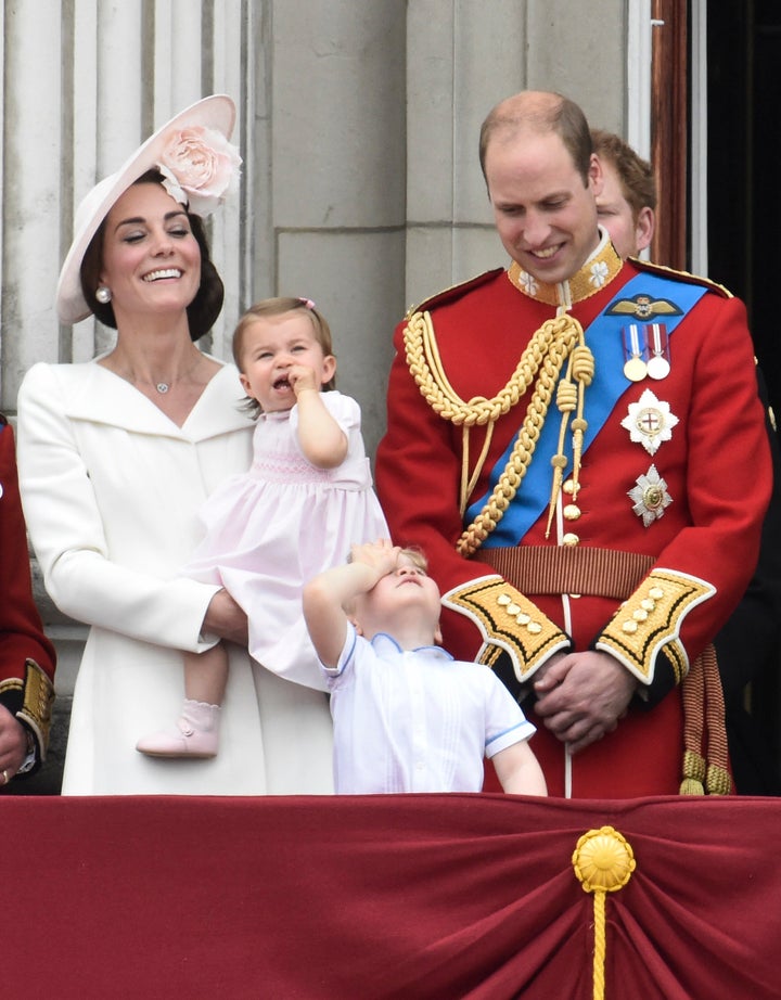 Catherine, Duchess of Cambridge holding Princess Charlotte, Prince George and Prince William, stand on the balcony of Buckingham Palace on June 11, 2016. 