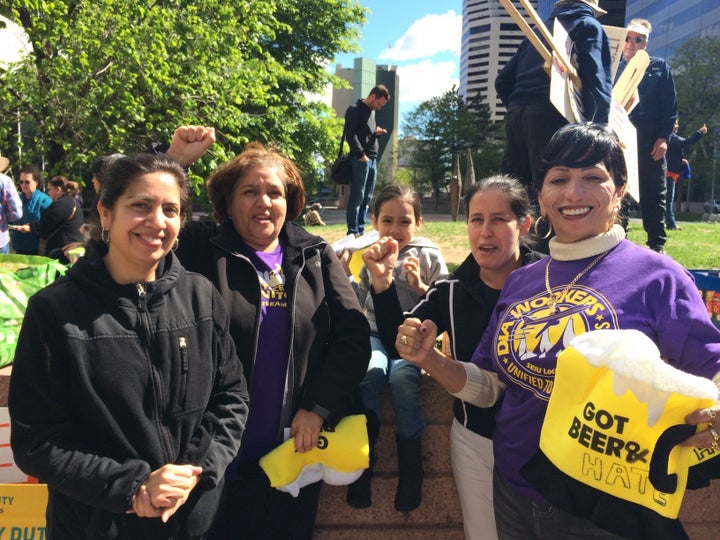 Eva Martinez, second from right, rallied with other union members in Denver, as protesters chanted, "Si se puede!"