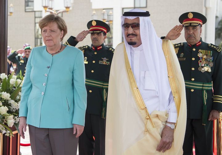 German Chancellor Angela Merkel (C) stands next to Saudi Arabia's King Salman bin Abdulaziz Al Saud (R) before their official talks in Riyadh, Saudi Arabia on April 30, 2017.