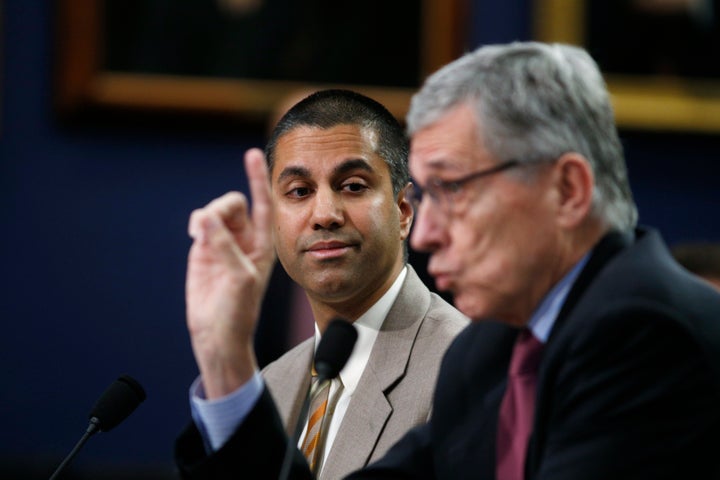 Ajit Pai, then-commissioner of the Federal Communications Commission, listens as then-FCC Chairman Tom Wheeler testifies on C