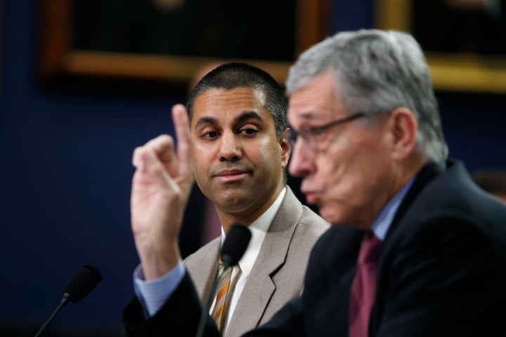 Ajit Pai, then-commissioner of the Federal Communications Commission, listens as then-FCC Chairman Tom Wheeler testifies on Capitol Hill on March 24, 2015.