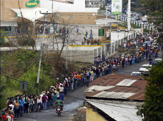 <p>Venezuelans waiting in long lines for food.</p>