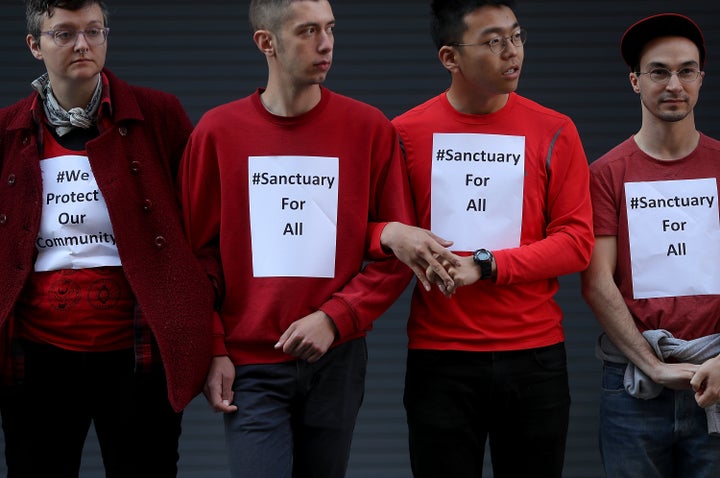 Protesters stand arm-in-arm to block the entrance to a U.S. Immigration and Customs Enforcement office in San Francisco. 