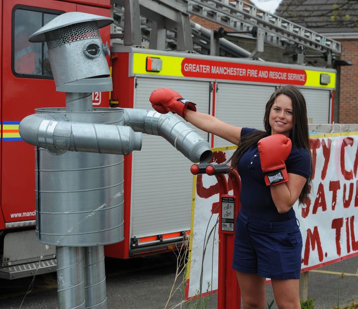 Karen Danczuk joins firemen from Heywood Fire Station in a charity car wash to raise funds for a new boxing club.