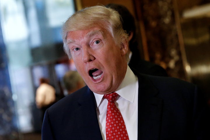 President-elect Donald Trump reacts to questions from reporters in the lobby at Trump Tower in New York, U.S., January 9, 2017