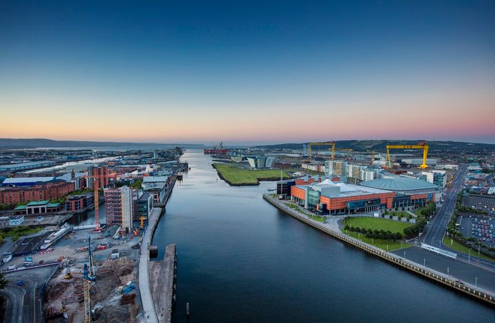 <p>Belfast’s Clarendon Dock area on the River Lagan. The iconic “Samson and Goliath” gantry cranes on right.</p>