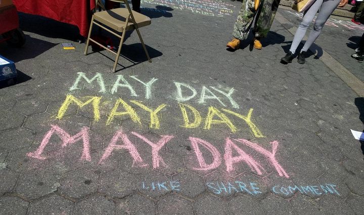 "May Day" was written in chalk on the sidewalk during the Union Square rally held for immigrants and refugees on May 1.