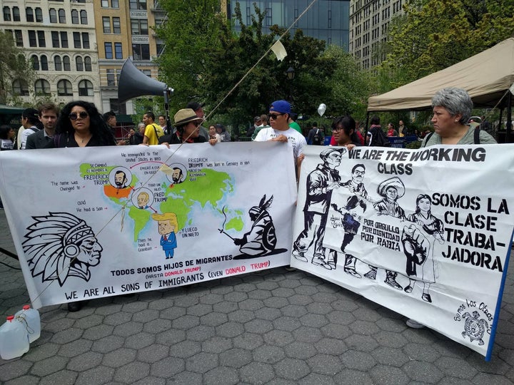 Emanuel Martinez (center, in blue cap) holds up signs he and members of the activist collective Somos Los Otros NYC brought t
