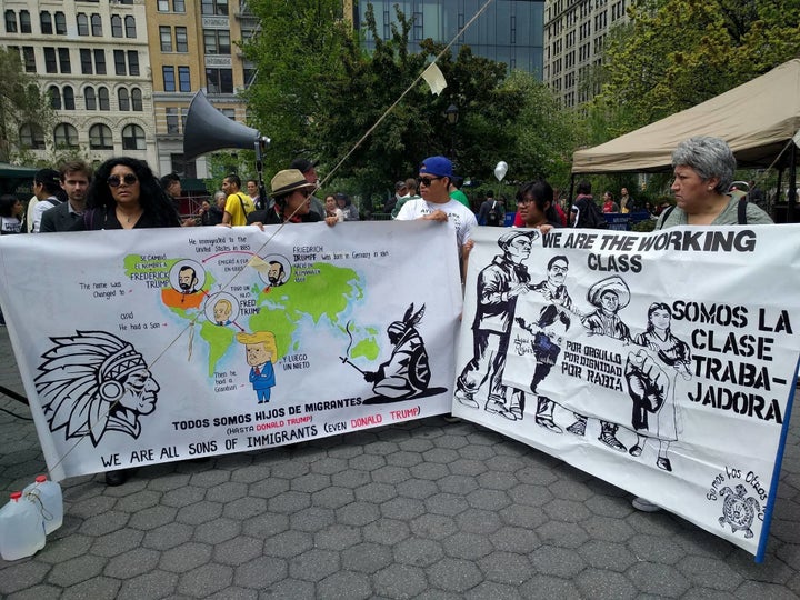 Emanuel Martinez (center, in blue cap) holds up signs he and members of the activist collective Somos Los Otros NYC brought to the rally.