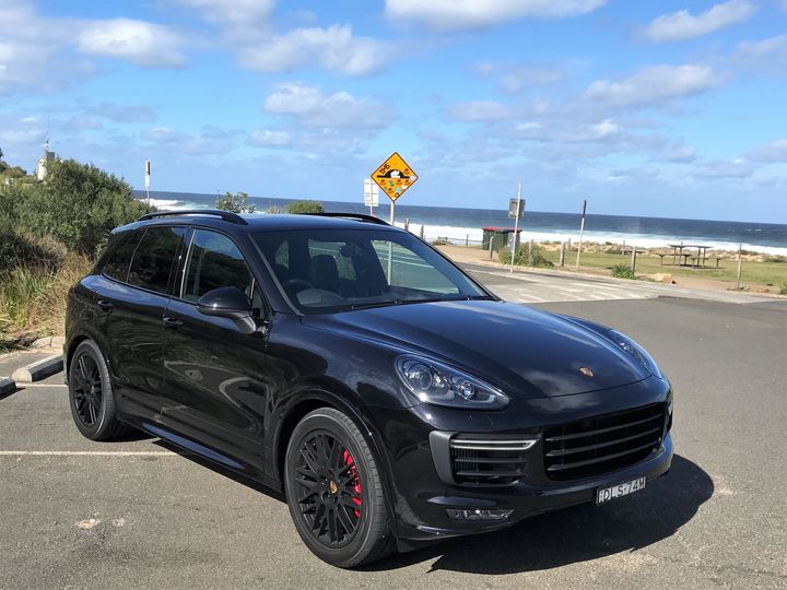 2017 Porsche Cayenne GTS at a beach location.