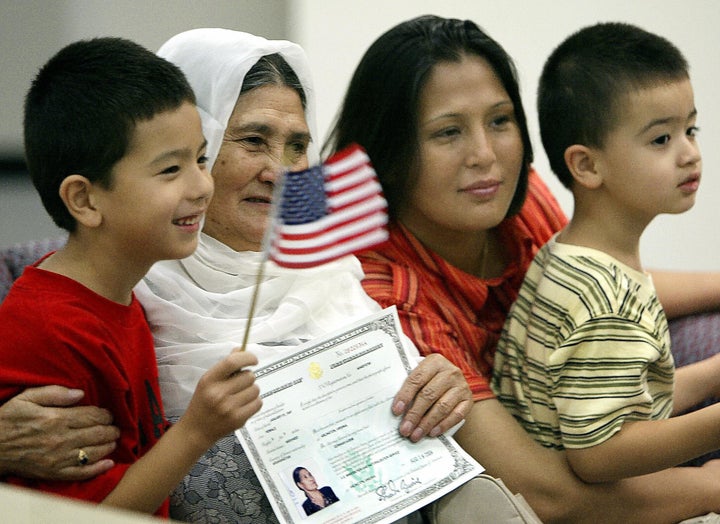 An Afghan family poses for a family photo after their grandmother is sworn in as a U.S. citizen in 2004 in Arlington, Virginia.